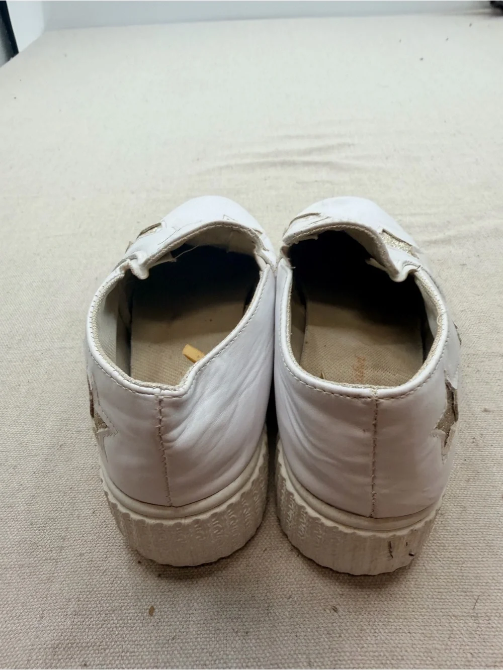 ' White Slip-On Sneakers with Gold Star Accents